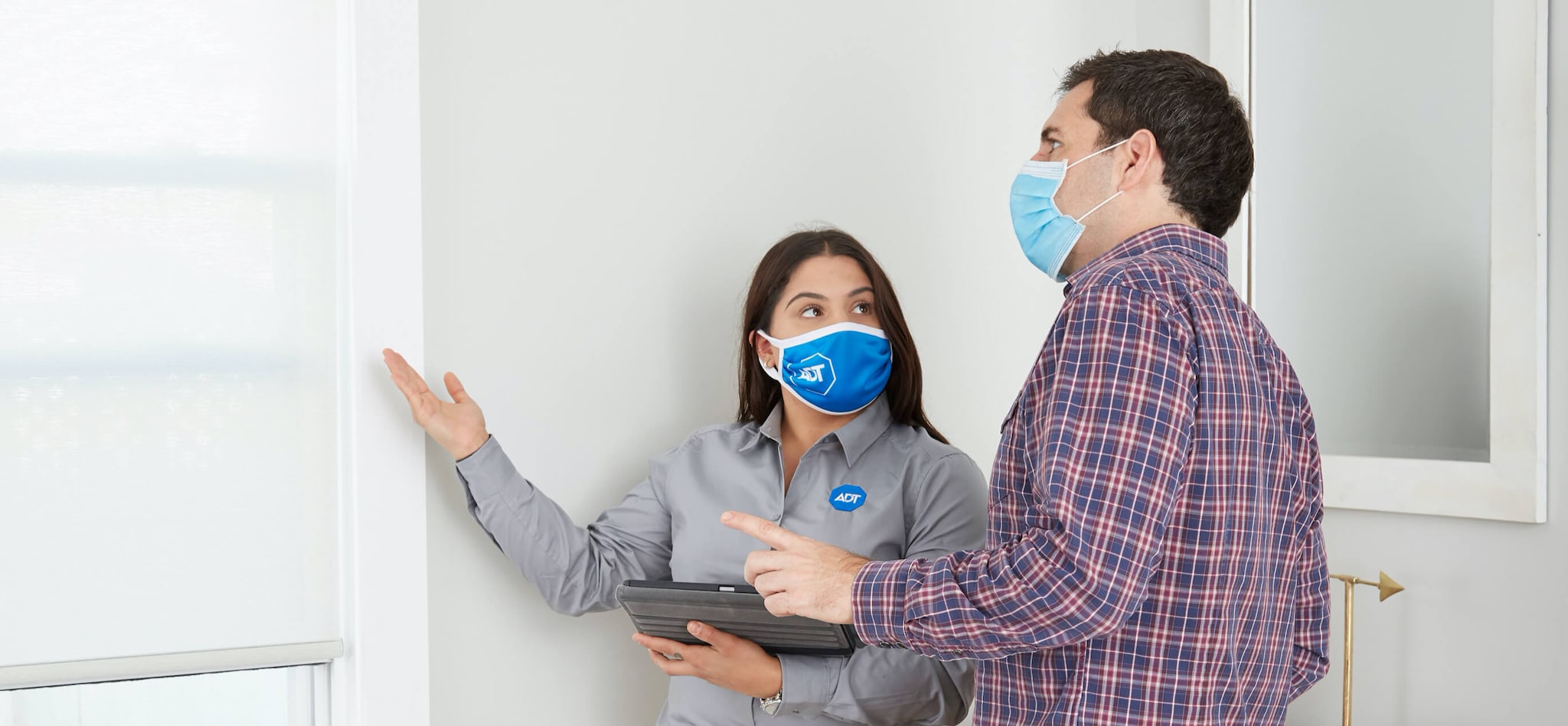 ADT sales agent with customer wearing face masks ADT sales agent with customer wearing face masks