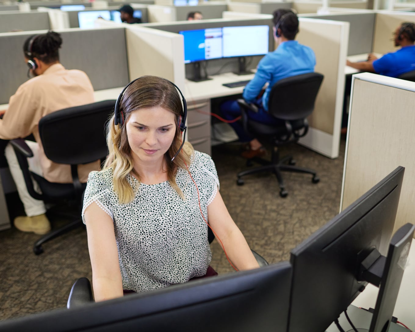 ADT call center employee smiling and talking into a headset ADT call center employee smiling and talking into a headset