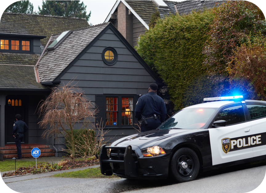 Police car in front of a house protected by ADT