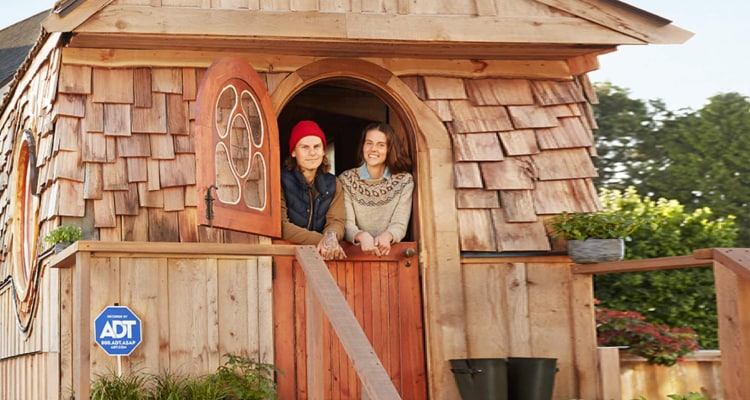 Smiling couple in a tiny house protected by ADT home security