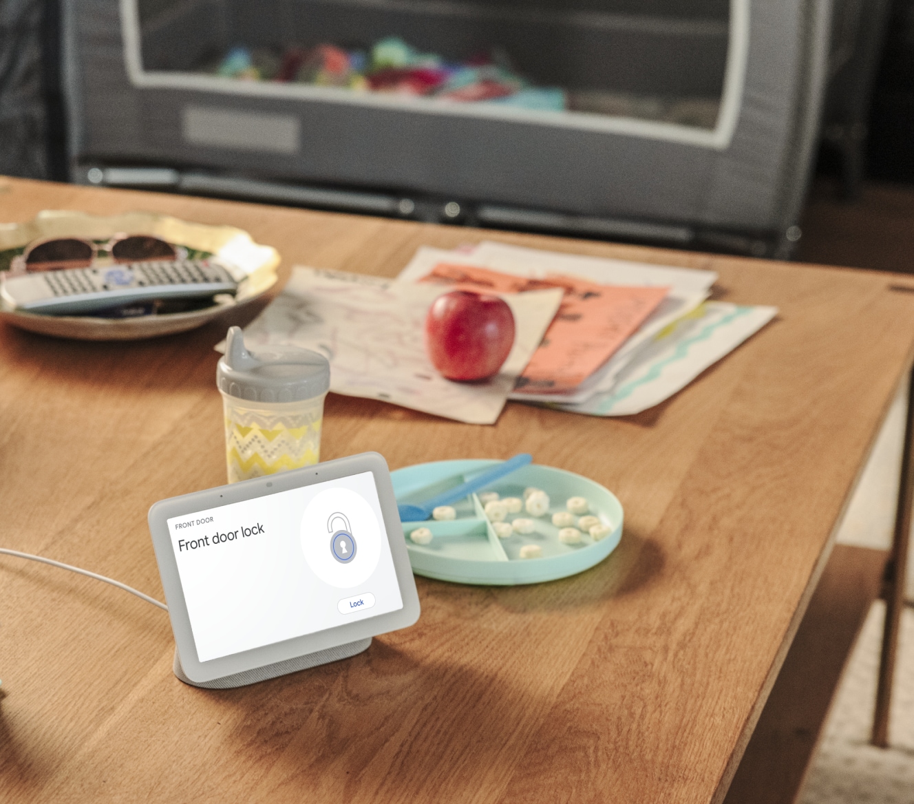 Google Nest Hub 2nd Gen on a kitchen table showing that a home's front door is locked Google Nest Hub 2nd Gen on a kitchen table showing that a home's front door is locked