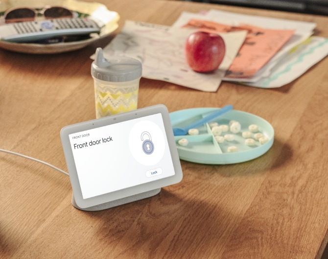 Google Nest Hub 2nd Gen on a kitchen table showing that a home's front door is locked Google Nest Hub 2nd Gen on a kitchen table showing that a home's front door is locked