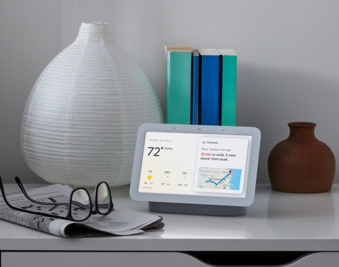 Google Nest Hub 2nd Gen on a bedside table displaying the weather and other stats Google Nest Hub 2nd Gen on a bedside table displaying the weather and other stats