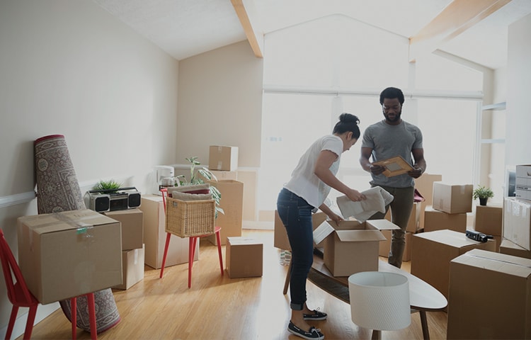 How to Prepare for Your Move to Help Keep Your Belongings Safe A couple packing their things into moving boxes