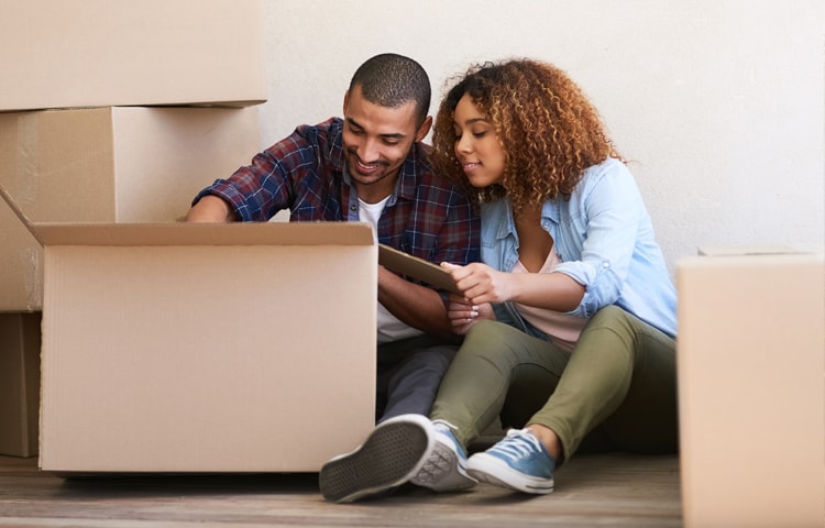 The Ultimate New Home Checklist for Your Move A couple packing a box to move