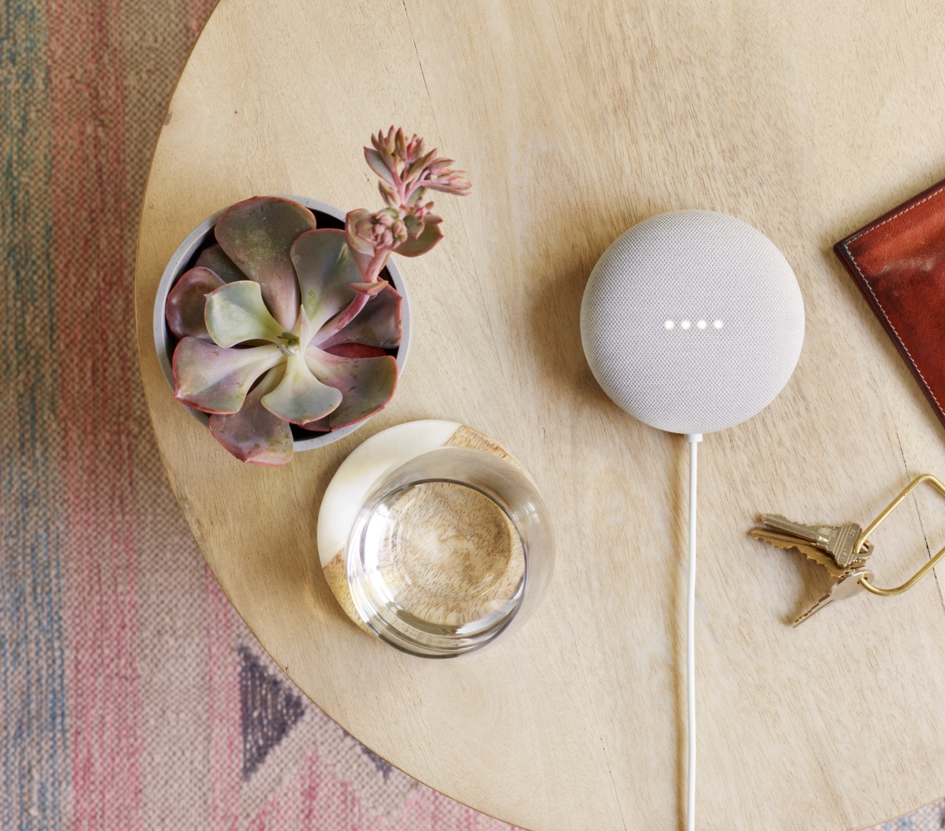 Google Nest Mini on a table with succulent and house keys Google Nest Mini on a table with succulent and house keys