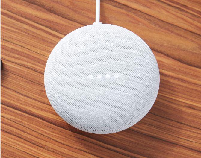 Google Nest Mini (2nd gen) on a wooden table Google Nest Mini (2nd gen) on a wooden table