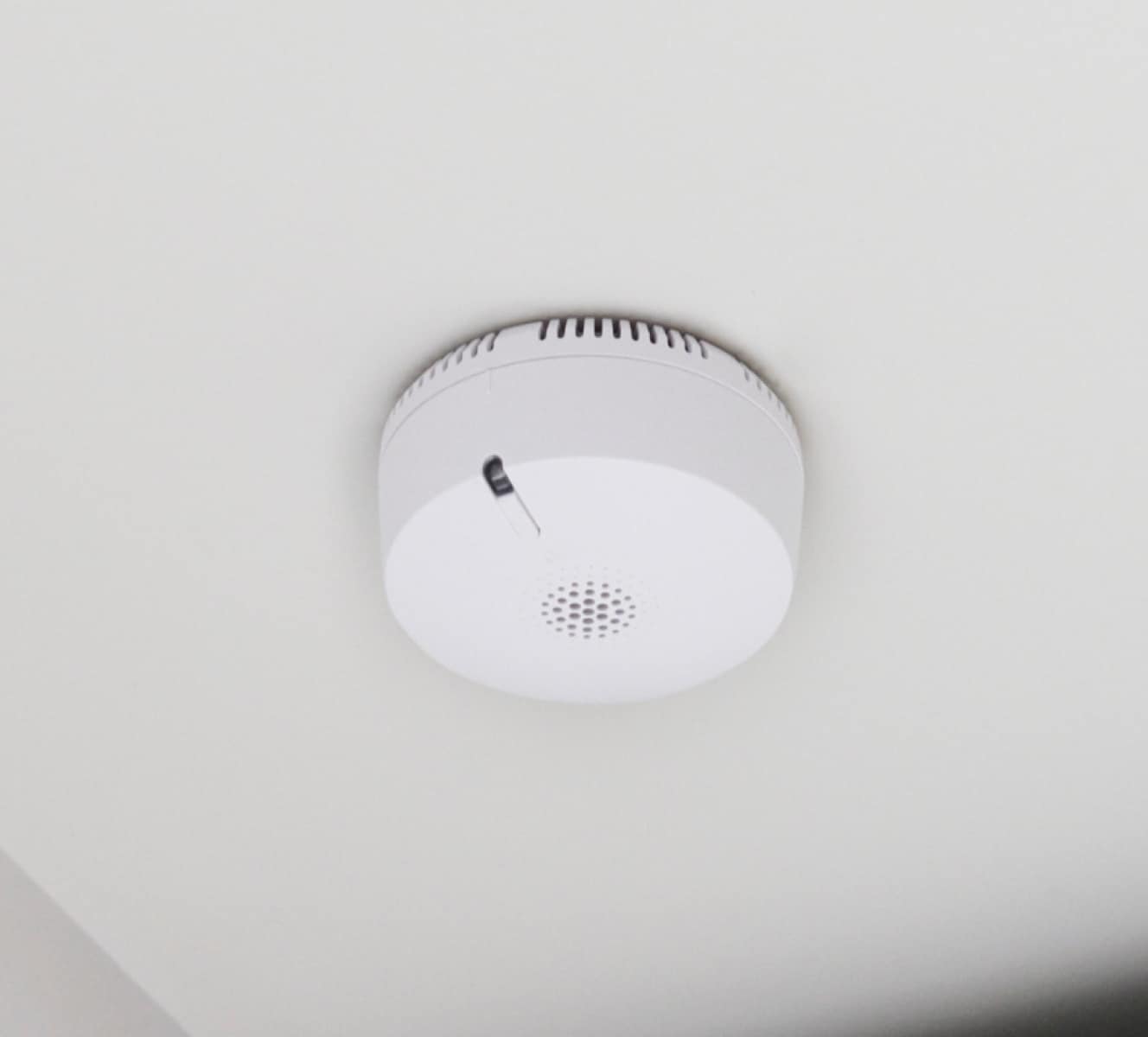 ADT smoke detector on a ceiling in a home ADT smoke detector on a ceiling in a home