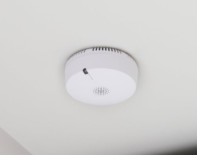 ADT smoke detector on a ceiling in a home ADT smoke detector on a ceiling in a home